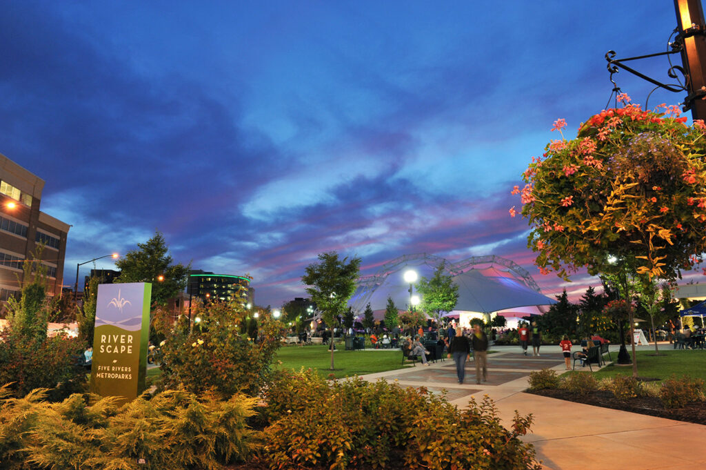 People walking through Riverscape Metro Park at night