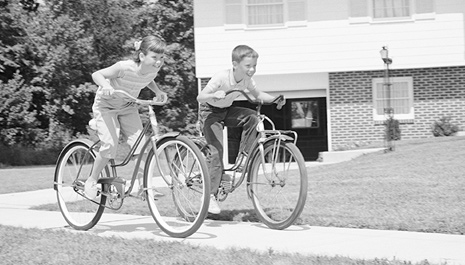 two kids riding bikes