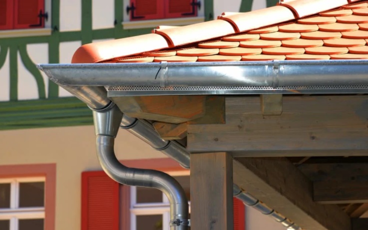 Stainless steel gutter running along the roof of a home.