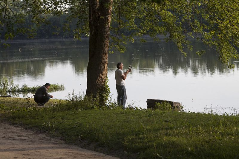 Man fishing on the banks of Cedar Lake in Dayton’s Carriage Hill MetroPark.