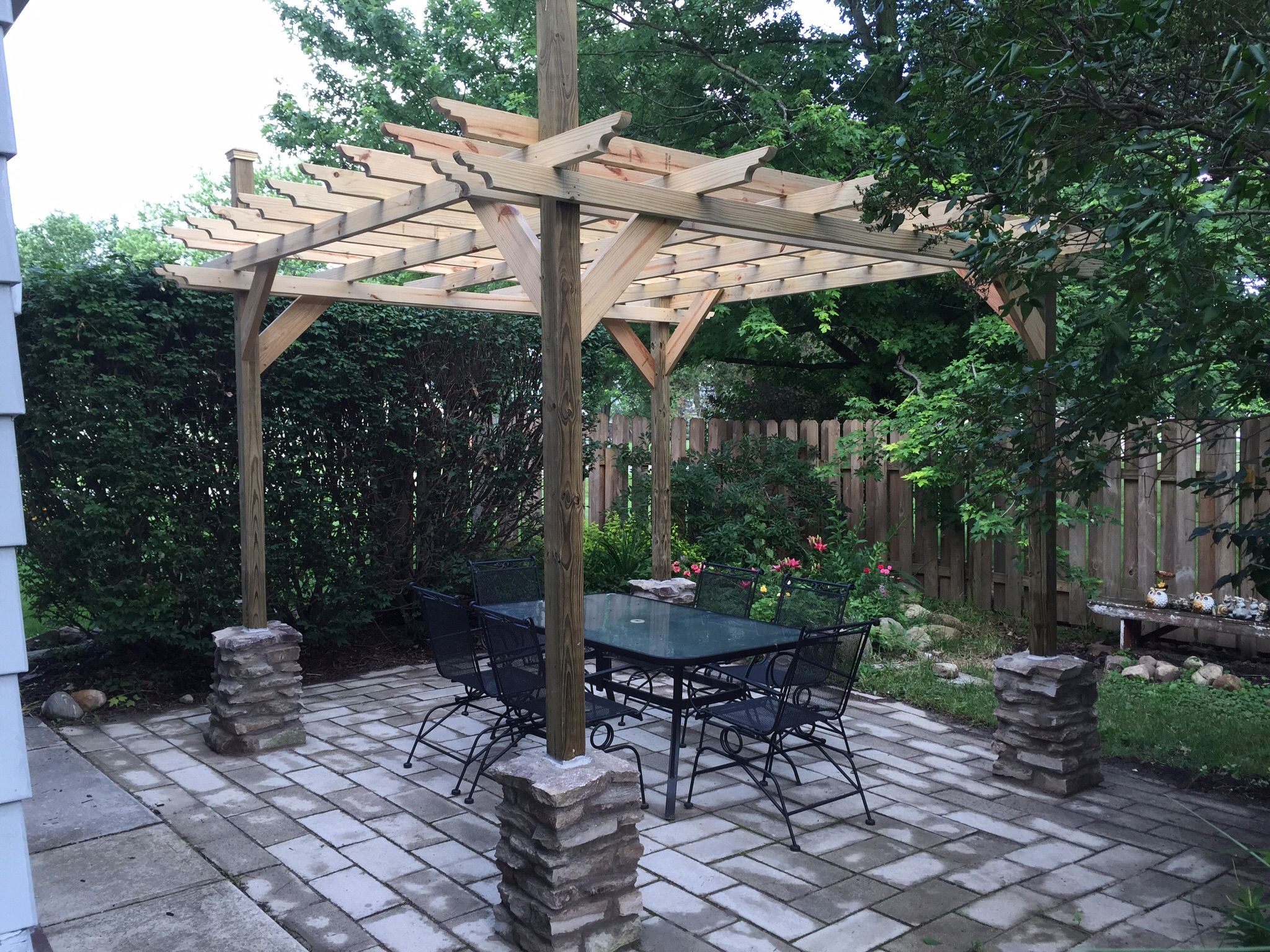 Backyard dining area with a pergola.