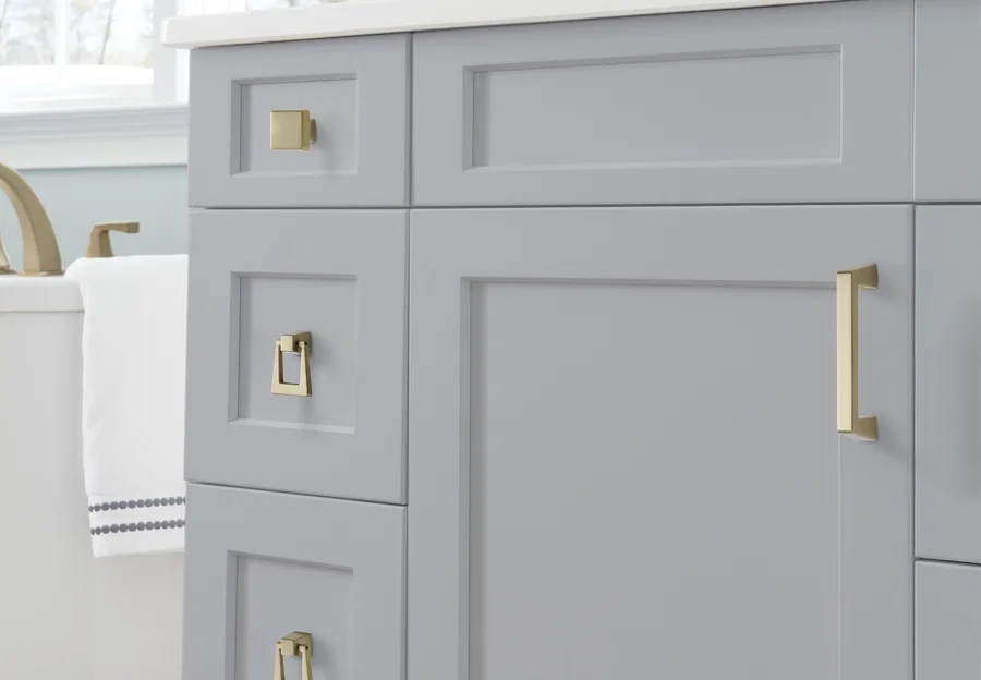 Gold hardware gives a gray bathroom vanity a fresh look.