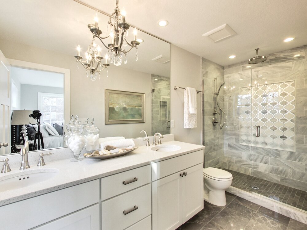 Chandelier light fixture adds an elegant touch to a bathroom.
