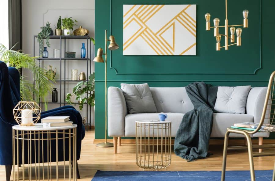 Green accent wall adds an elegant feel to a living room.