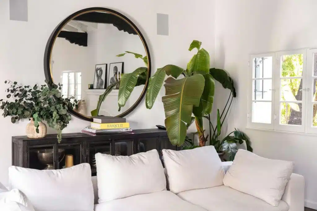 Mirror hung on a living room wall to add extra light and the illusion of more space