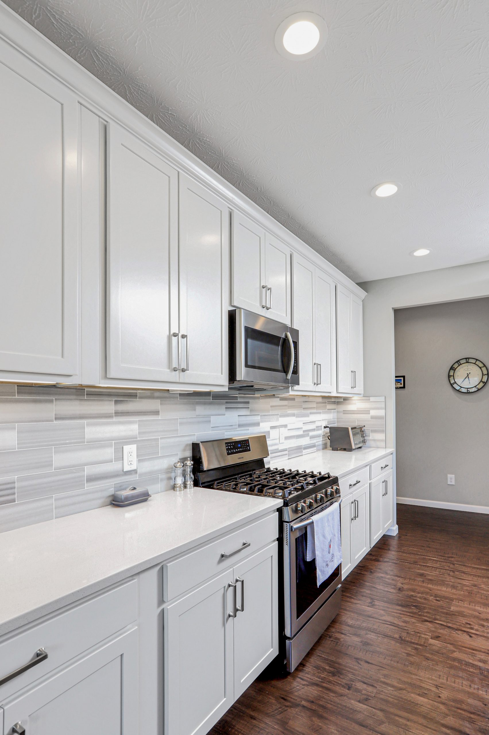 Neutral kitchen with pops of color added by floral arrangements.