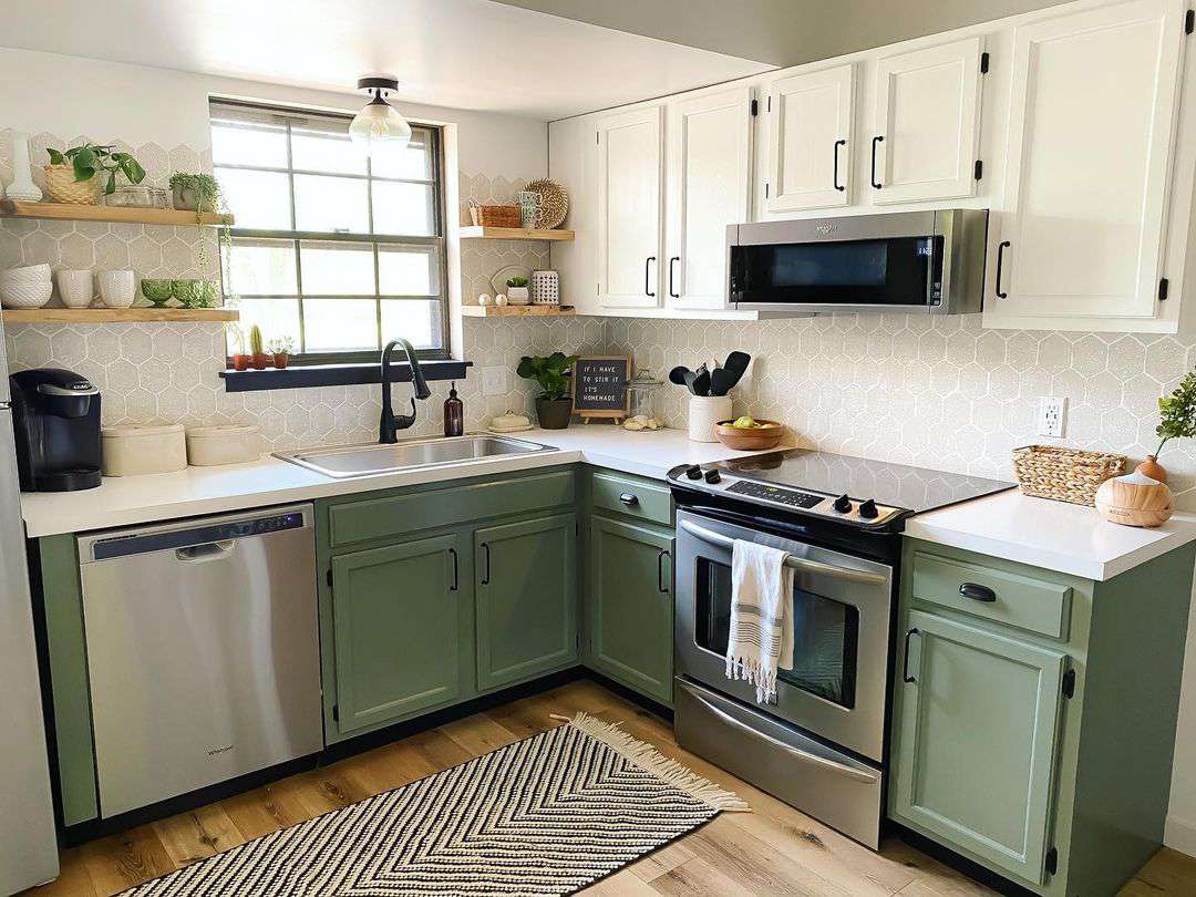 Bottom cabinets in kitchen painted with sage green color.