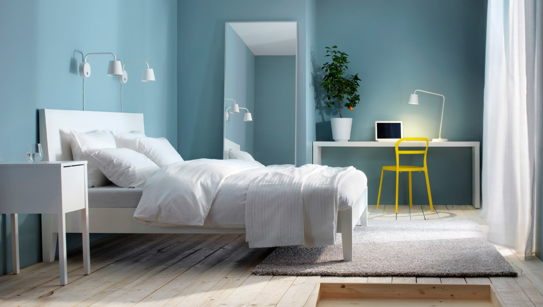 Minimalist bedroom with light blue walls