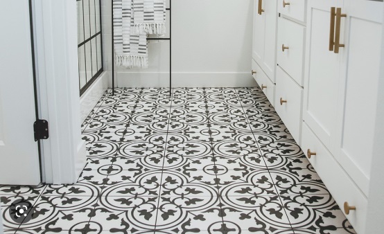 Black and white tile pattern provides a statement design focal point in white bathroom.