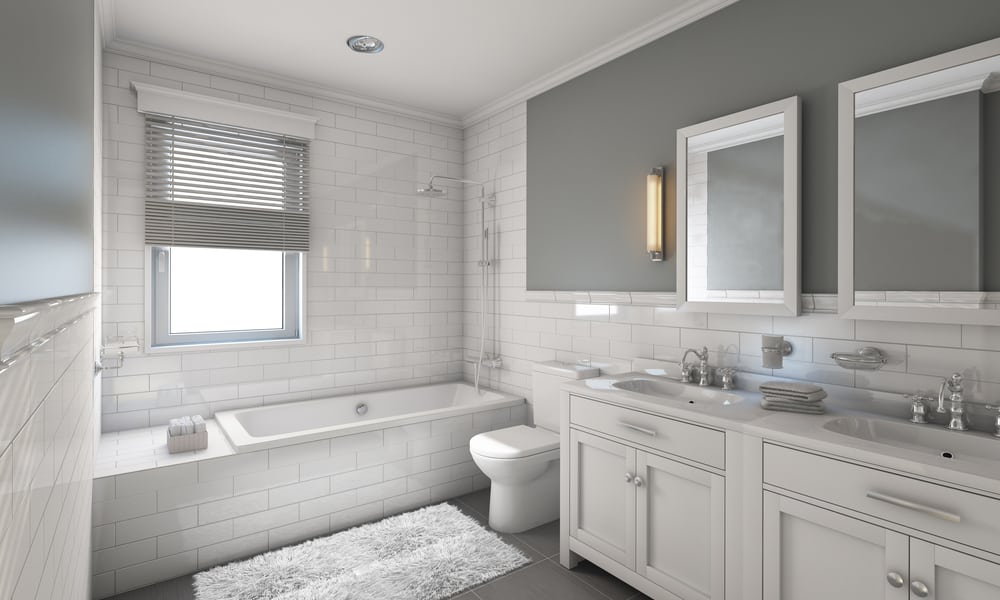 Full bathroom with white fixtures and tile and a clean design.