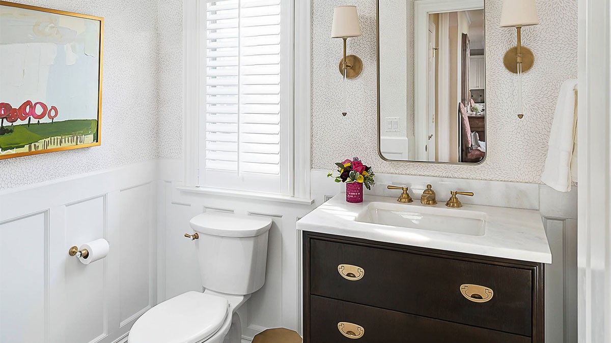 Compact half bathroom with toilet and vanity positioned adjacently.