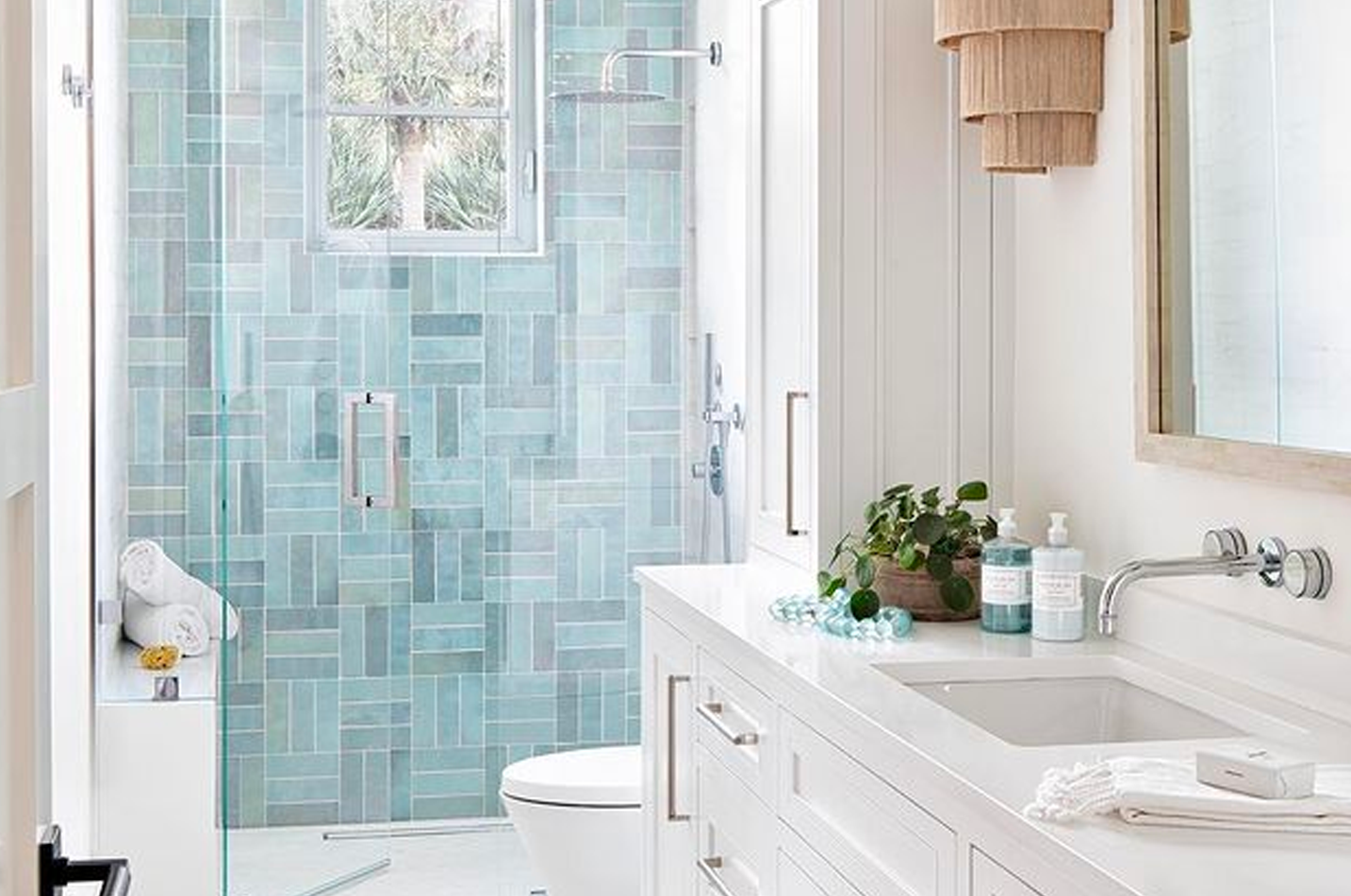 Blue patterned subway tile installed floor-to-ceiling in a walk-in shower.