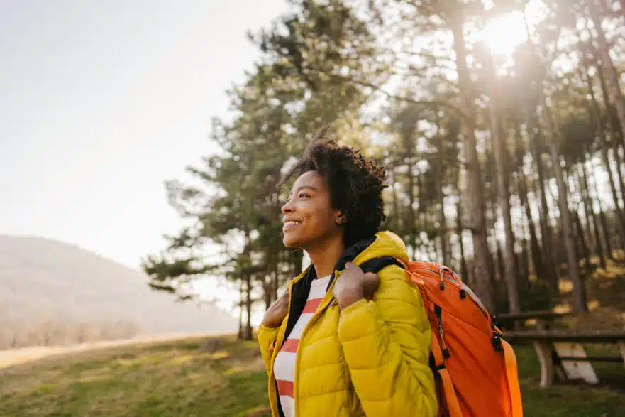 Woman smiling on a hike.