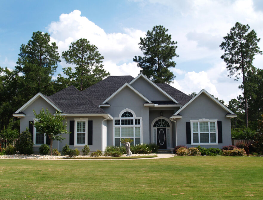 Single-story home plans lay atop each other with a 3D image of the uppermost design.