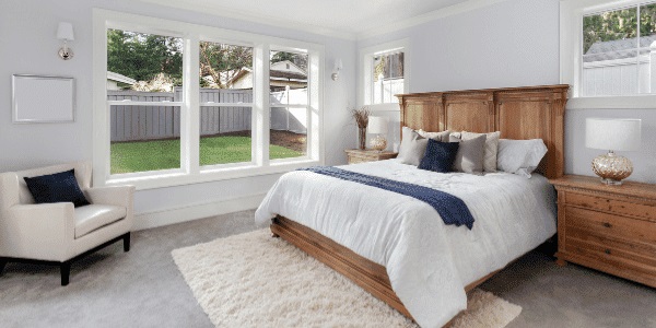 First-floor bedroom with windows looking out to the backyard 