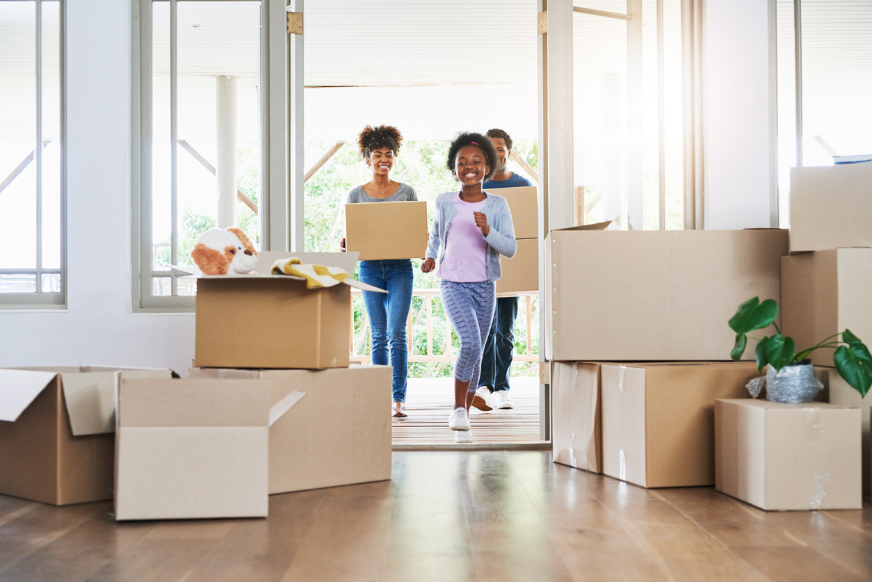 Excited family entering their brand new home